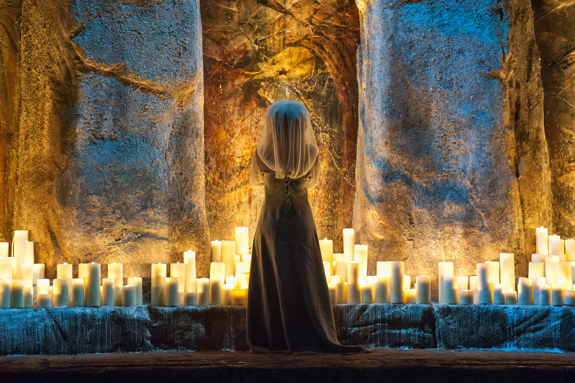 The veiled figure among the candles in Macbeth