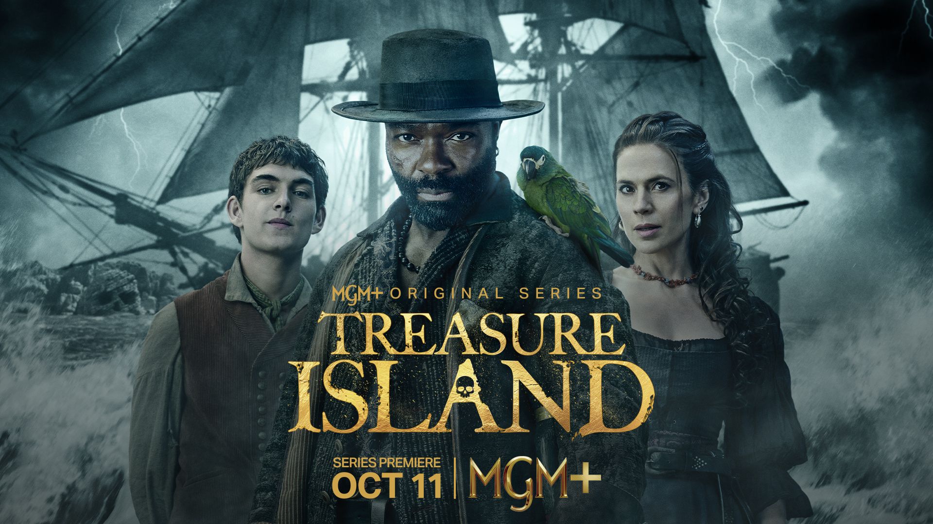 Treasure Island — MGM+ Original Series. David Oyelowo as Long John Silver with his parrot, between Tom Sweet and Hayley Atwell, a storm-lashed ship behind. Series premiere October 11 on MGM+.