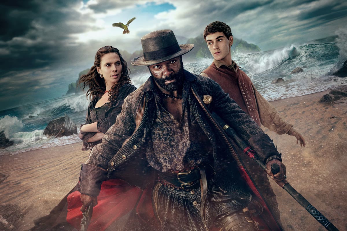 David Oyelowo as Long John Silver on a storm-lashed beach with Hayley Atwell and Tom Sweet in Treasure Island