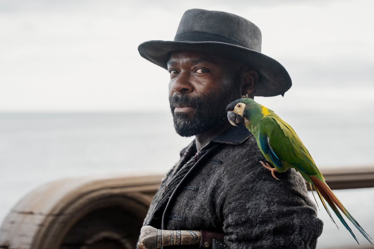 David Oyelowo as Long John Silver with his parrot in Treasure Island